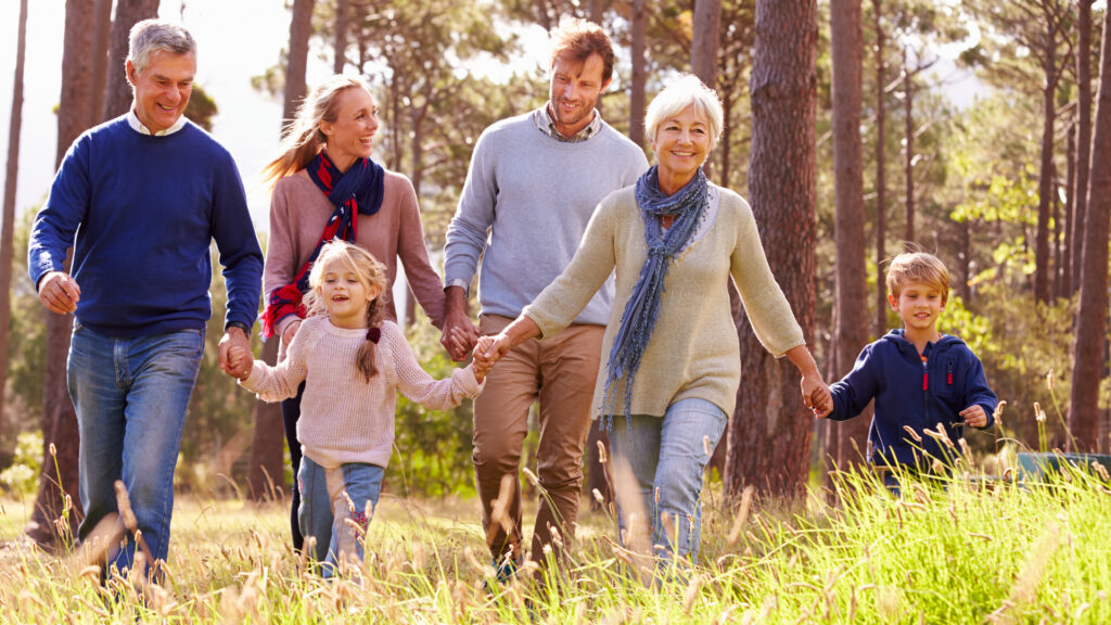 A multi-generational family walking through the countryside.