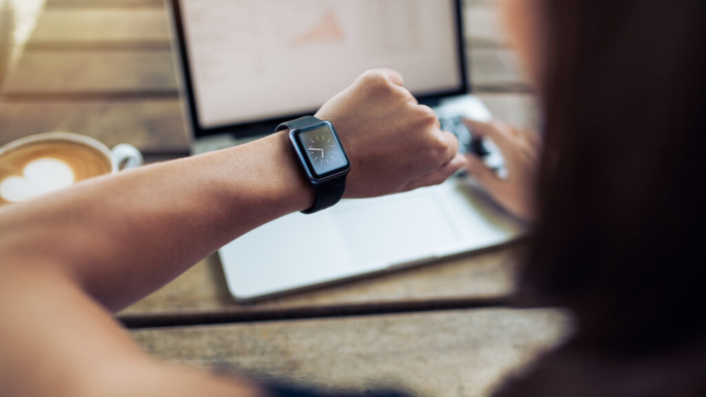 A woman checking the time on a watch. 