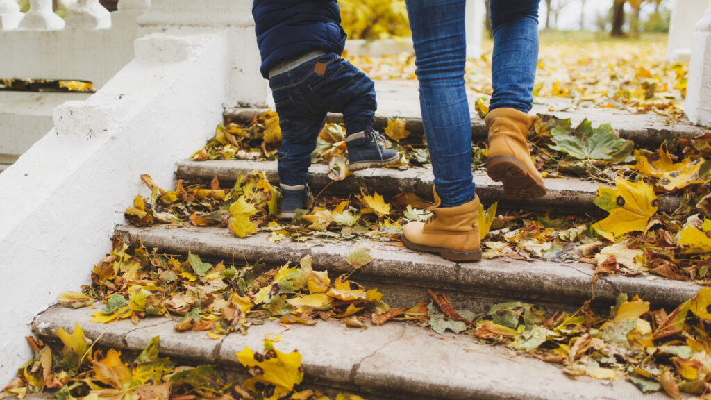 A woman and child walking up some steps.