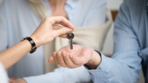 A couple receiving keys from an estate agent.