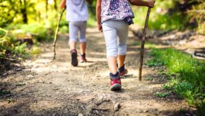 Two children hiking in a forest.