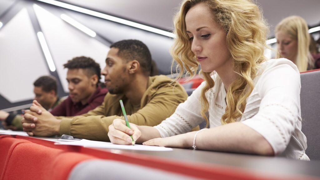 A group of students in a university lecture hall.