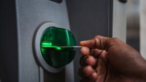 Someone inserting a card into an ATM.