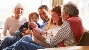 A multi-generational family sitting on the sofa.